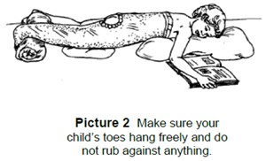 Child laying on their stomach with the cast on their leg.