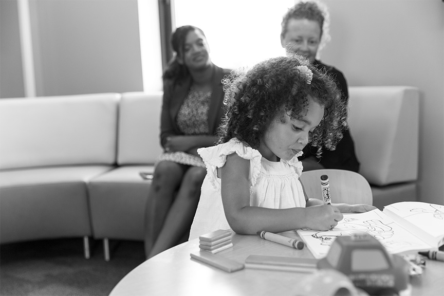 little girl coloring a coloring book