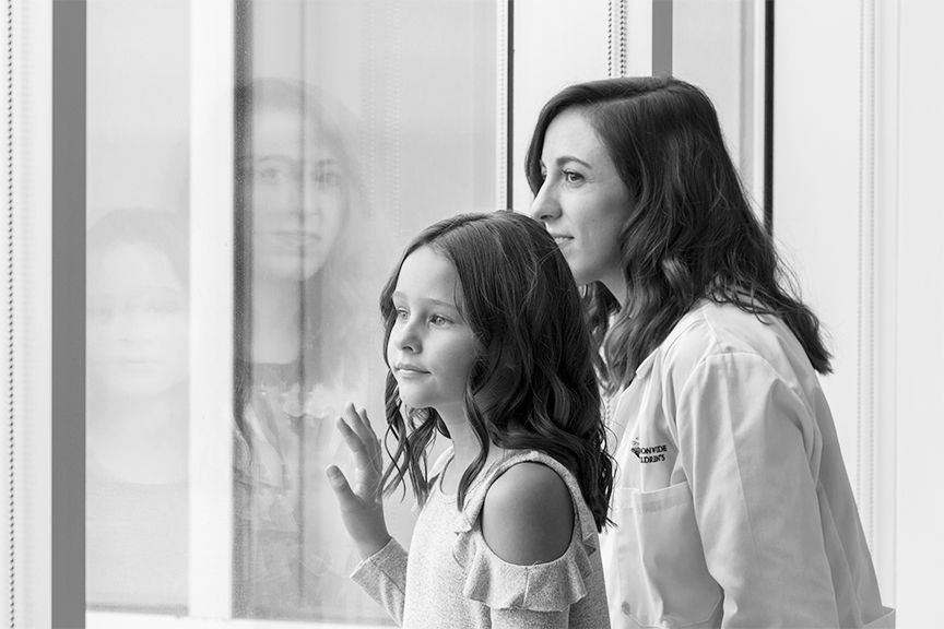 Doctor and patient look out windows