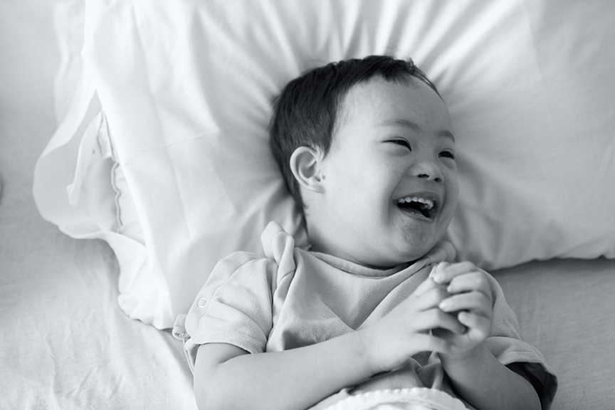 Laughing boy in hospital bed