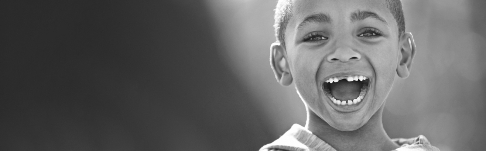 Elementary age boy, smiling with mouth wide open