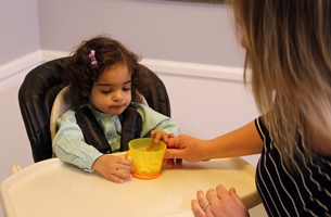 Mom with her child sitting in a highchair