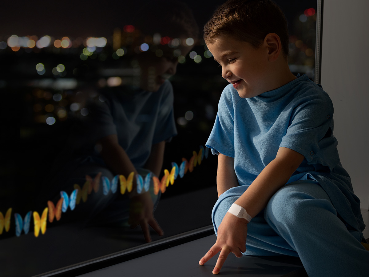 Toddler being treated at hospital sitting in a crib